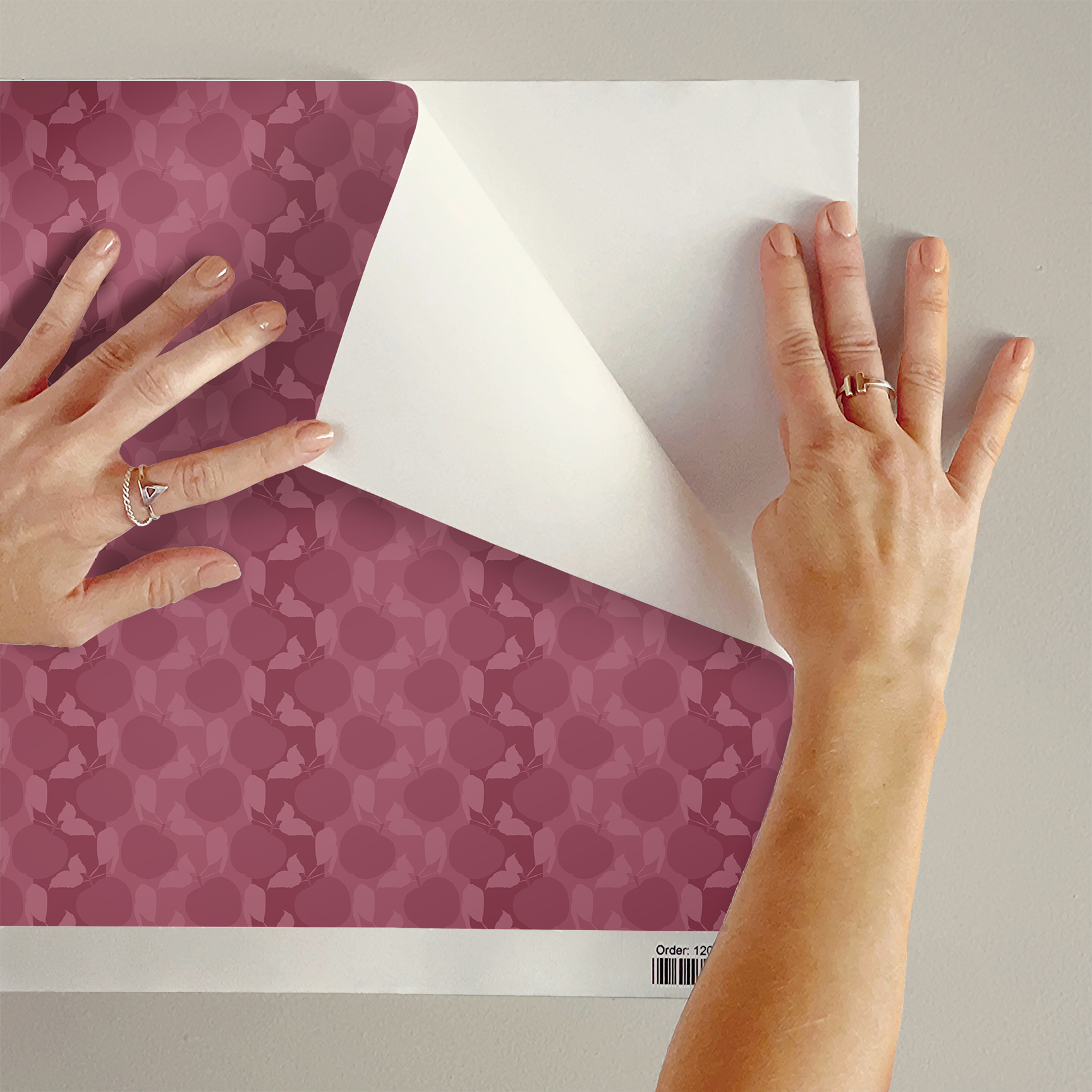 The artwork is a textile or fabric sample with a repeating pattern of apples, and Leaves. The entire design is rendered in different shades of muted reddish-pink, creating a monochromatic effect.  The apples are round and prominent, surrounded by simple, stylized leaves and butterflies, creating a harmonious and nature-inspired motif. The arrangement is dense, ensuring no empty spaces, which gives the fabric a rich and textured visual appeal.